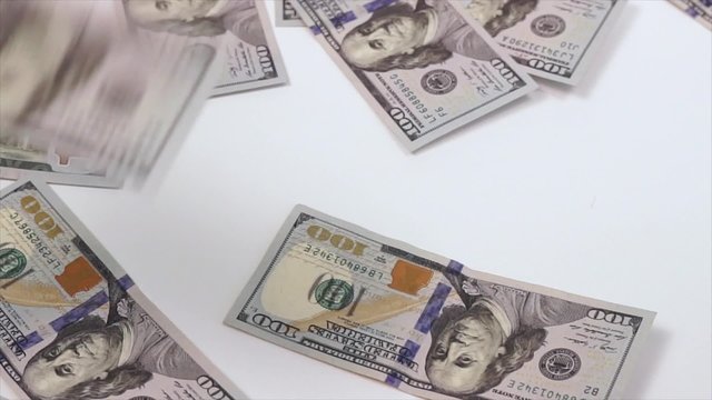 falling dollar bills on a white background