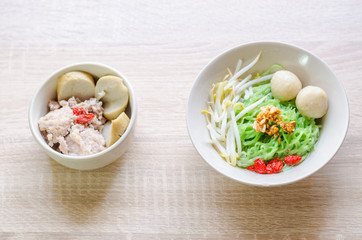 Thai Noodle with meat ball and crispy pork skin on wooden backgr