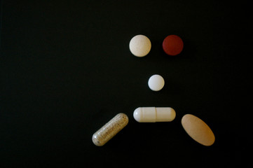 Medication pills forming a sad face