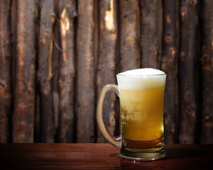 Cool beer on wood background.