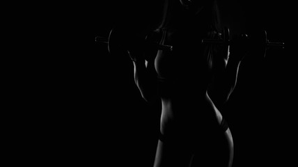 Brutal athletic woman pumping up muscles with dumbbells