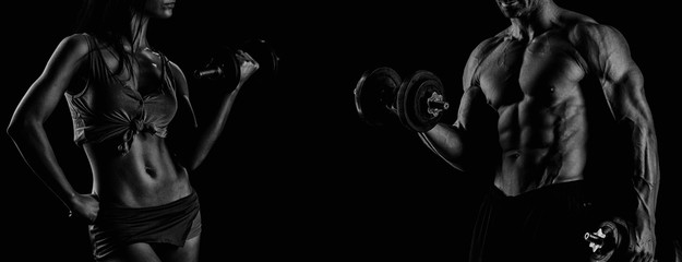 strong young couple working out with dumbbells. Shot in studio o