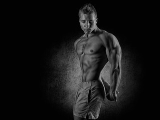 Fototapeta na wymiar Strong Athletic Man Fitness Model Torso showing six pack abs.