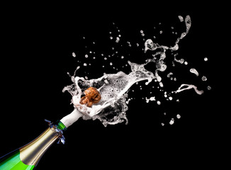  popping champagne bottle on black background. celebration, party and new year concept.