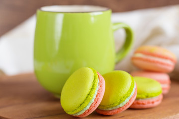 Green and pink colorful macaroons with green mug