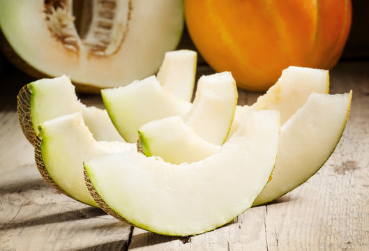 Ripe sliced  melon on a wooden background, selective focus