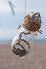 Seashells in a jar on the beach, vintage decor