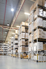 A distribution warehouse with high shelves - obrazy, fototapety, plakaty