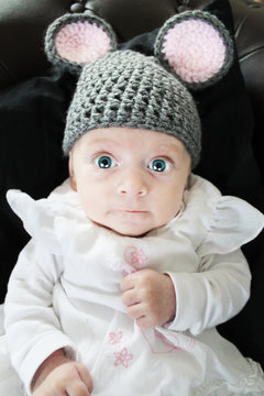 two months old baby girl wearing mouse cap