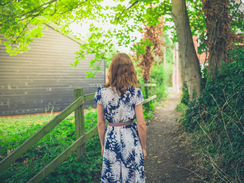 Young woman standing on path in the country