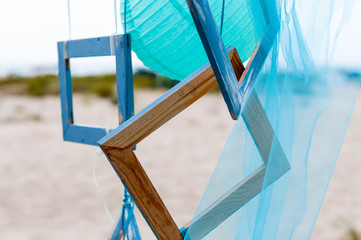 Summer beach decoration: photo frame with organza or silk on sea