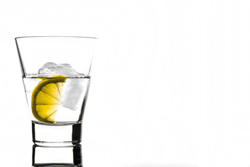 Beverage with lemon and ice in glass, isolated on white background