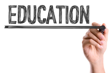 Hand with marker writing: Education