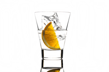 Beverage with orange and ice in glass, isolated on white background