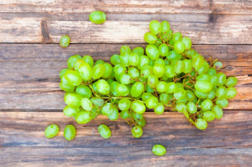 Green grape on grunge wooden background