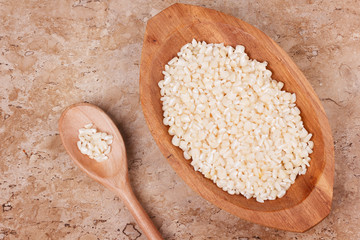 White grated corn kernels in wooden bowl