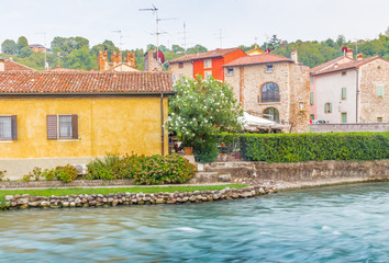Fototapeta na wymiar Waters and ancient buildings of Italian medieval village