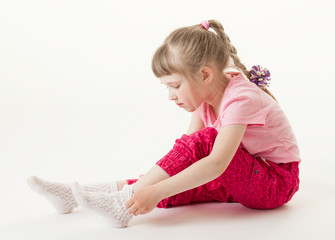 Pretty little girl trying on sock