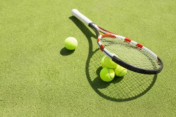 Rolgordijnen Tennis racket and balls on the court grass © Kaspars Grinvalds