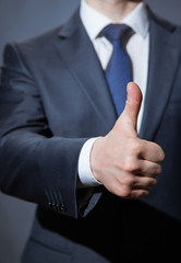 Unrecognizable businessman showing thumb up