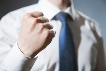 Unrecognizable businessman showing a strong fist