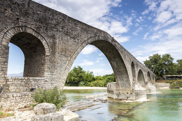 Fototapeta na wymiar The Bridge of Arta is an old stone bridge that crosses the Arach