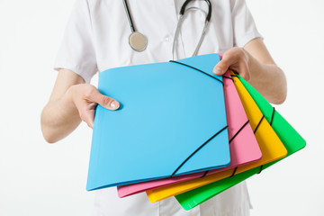 Unrecognizable doctor holding coloured folders