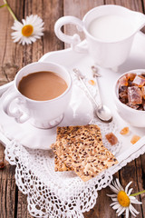 Coffee with milk and cookies on a tray. Romantic Breakfast with daisies.selective focus