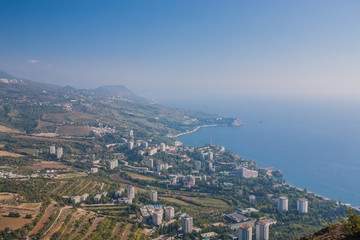 Small town on the Black Sea coast against blue sky with clouds.