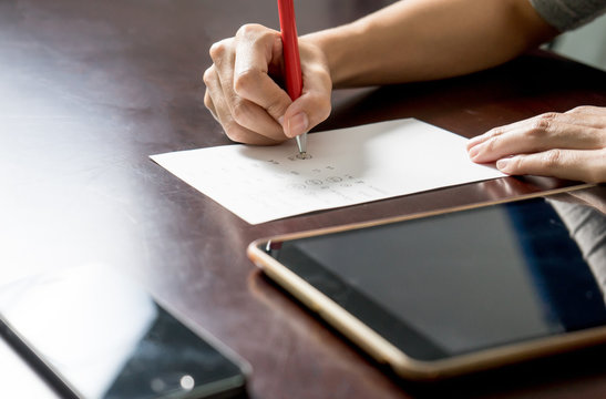close up of woman with tablet pc and write a paper 1