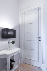 Fototapeta na wymiar White wooden door in modern apartment