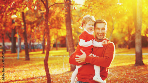 Happy family father and child daughter on a walk in autumn leaf
