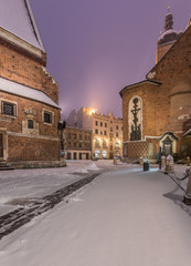 Krakow, Poland, Mariacki square between St Mary's church and St Barbara's church in winter