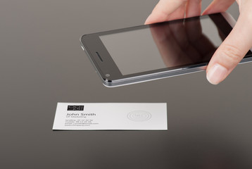 Business card with embedded NFC tag and phone