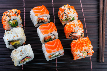 Salmon rolls on bamboo mat. japanese food style.