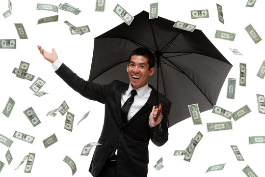 Business Man With Umbrella In Money Rain Storm