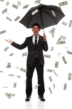Happy businessman with raining money