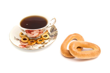 some different bagels and cup of tea on white