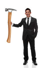 Businessman holding a gaint hammer to the side as a business too