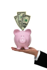 Businessman hand holding a piggy bank with money front view