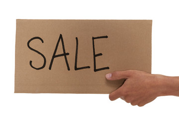 Hand holding up a cardboard sale sign