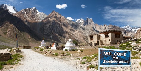 Village in Suru valley and signpost Welcome to Zanskar