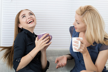 Two female friends talking and laughing together