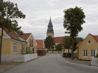 Fototapeta na wymiar Town of Skagen in Denmark. In the north of Denmark and particularly in the town of Skagen, traditionally the houses are painted yellow with a white trim and topped with orange roof tiles.