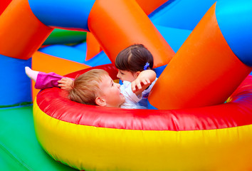 excited kids having fun on inflatable attraction playground