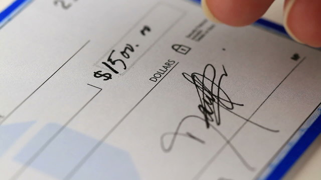 writing and signing a check for a large amount