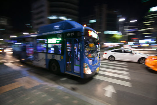 City bus motion blurred in the night