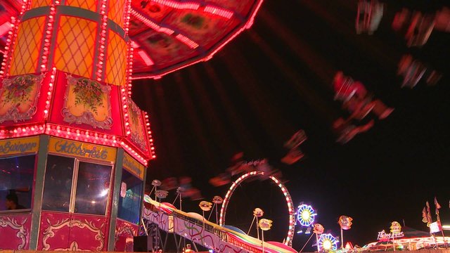Swings at a carnival at night.