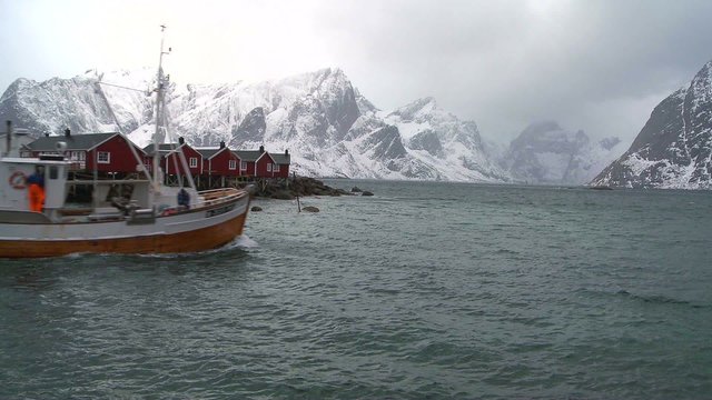 Fishing huts stand in rows in a village in the Arctic Lofoten Islands, Norway.