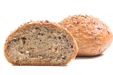 Fresh whole grain bread cut in half on white background
